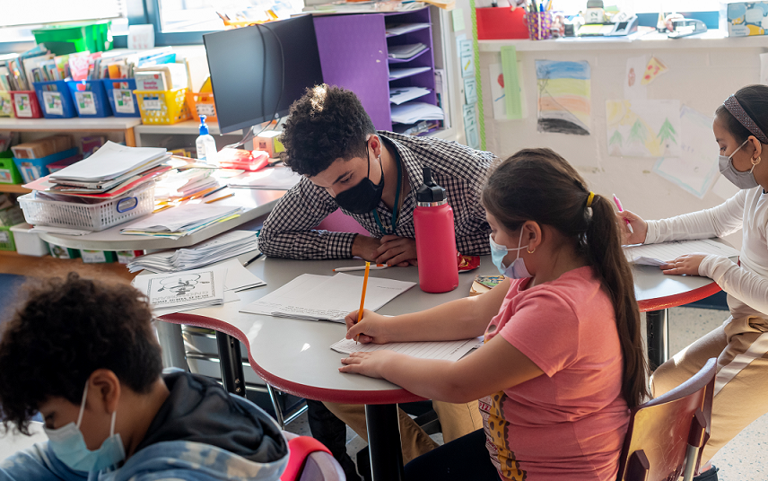 Julian Consolla helps students with a lesson at Mount Eagle Elementary.   ​